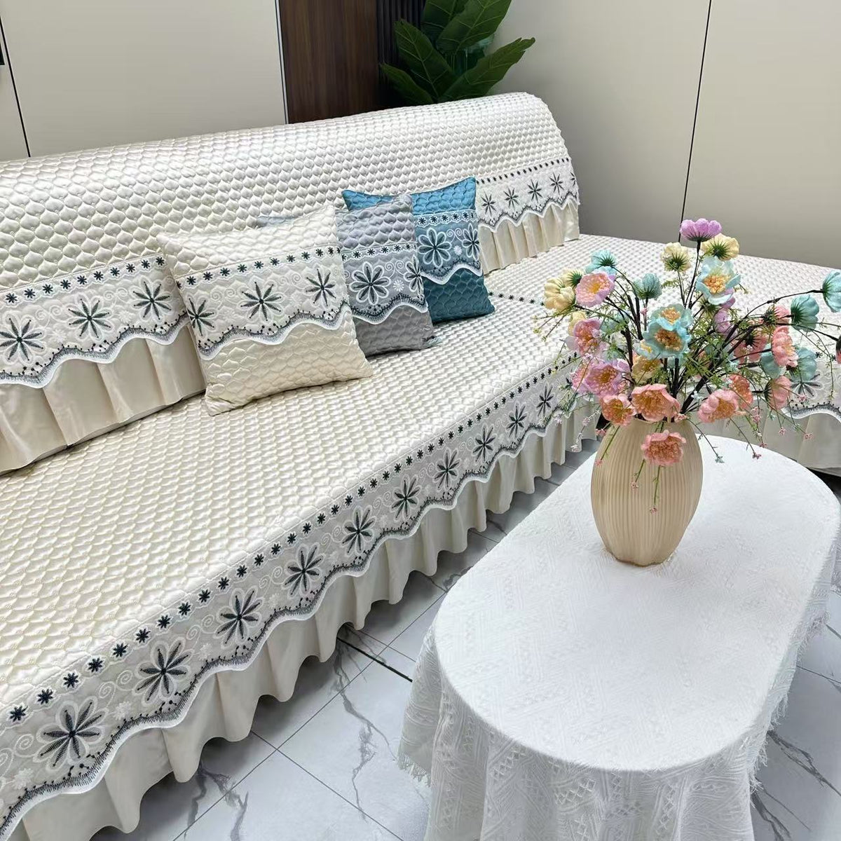 Elegant white quilted sofa cover in living room